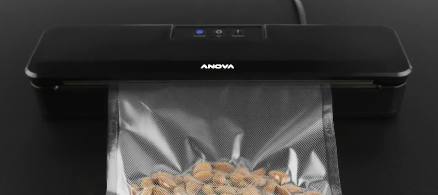 loads a bag into a vacuum sealer